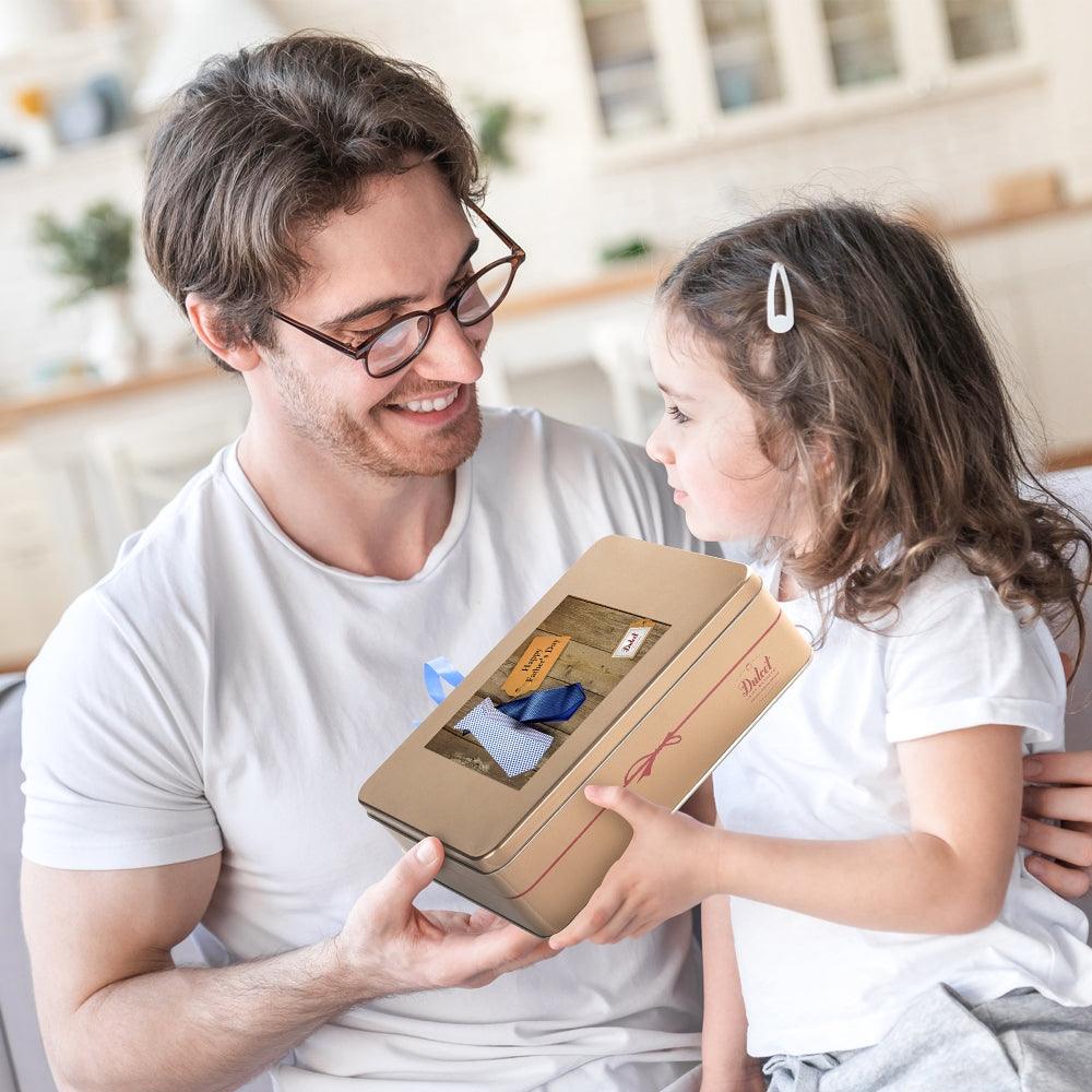 Deluxe Honey & Pastry Gift Tin: family holding and presenting a gift tin package