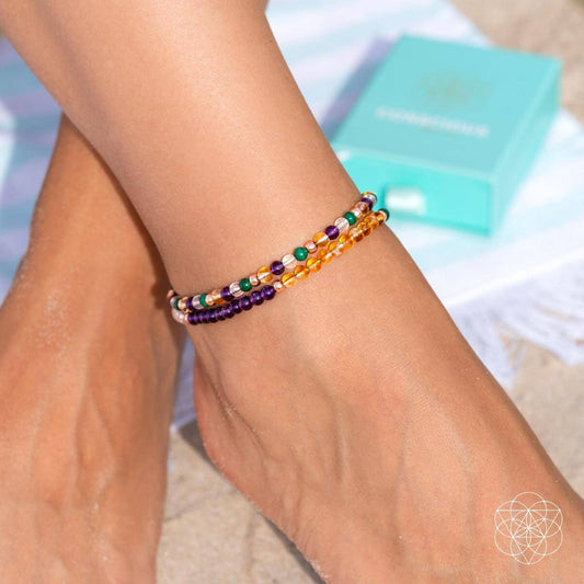 Beaded anklet set bracelet with purple, green, orange, and gold bead accents