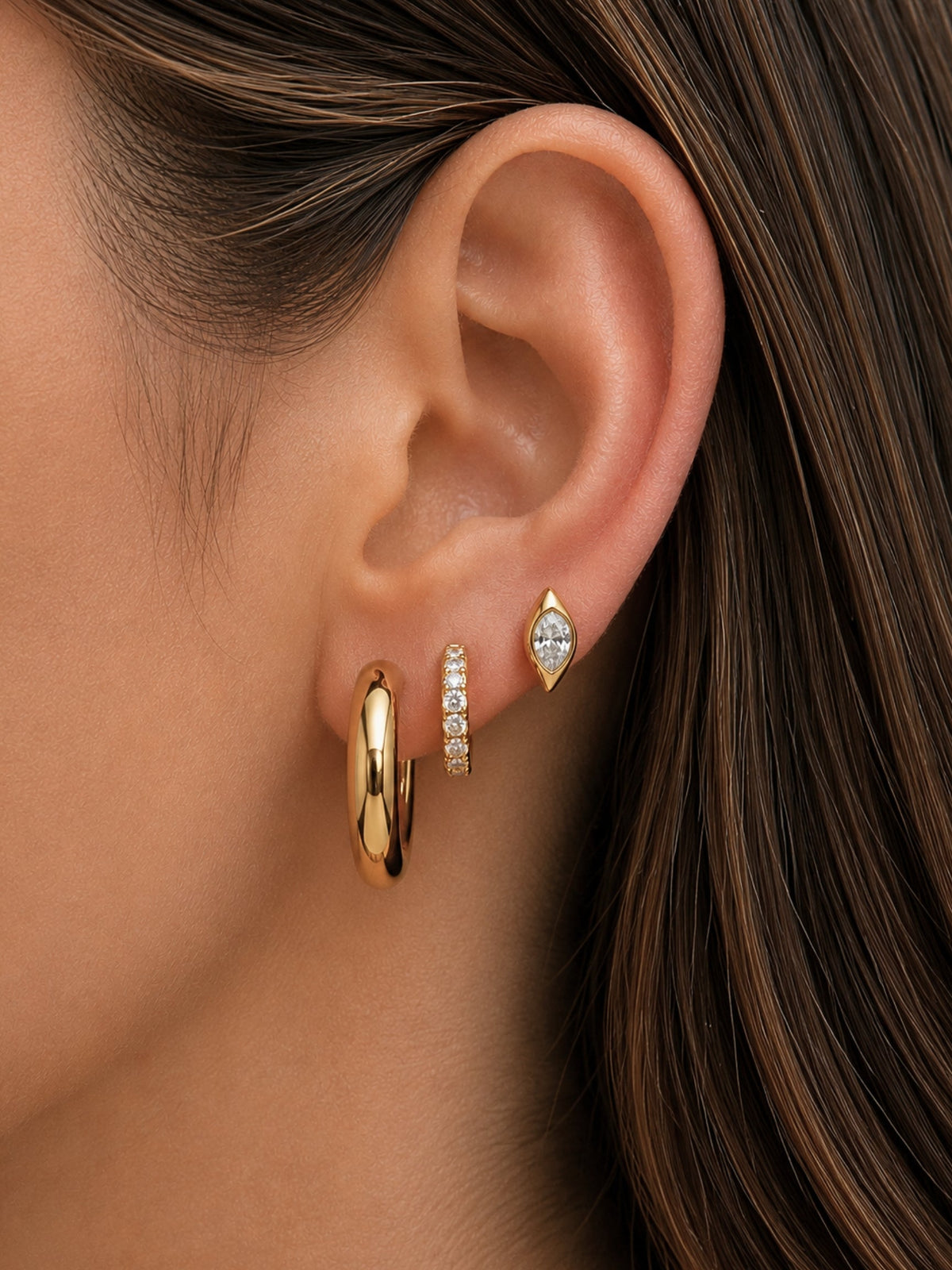 Gold hoop earrings with small crystal-accented detailing