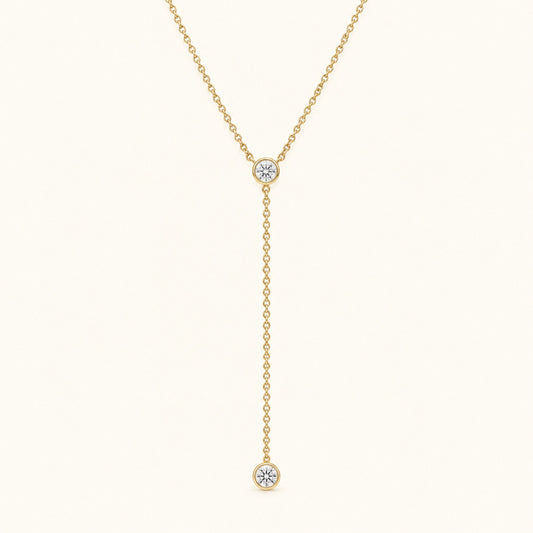 Gold-tone lariat necklace with round diamond bezel pendant and hanging drop