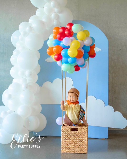 White balloon garland with large white clusters and colorful balloon accents at top