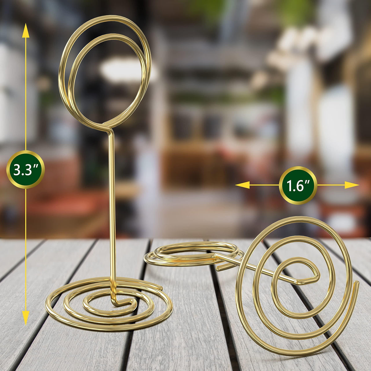 Gold table number holder stand shown with size arrows: spiral base and oval frame