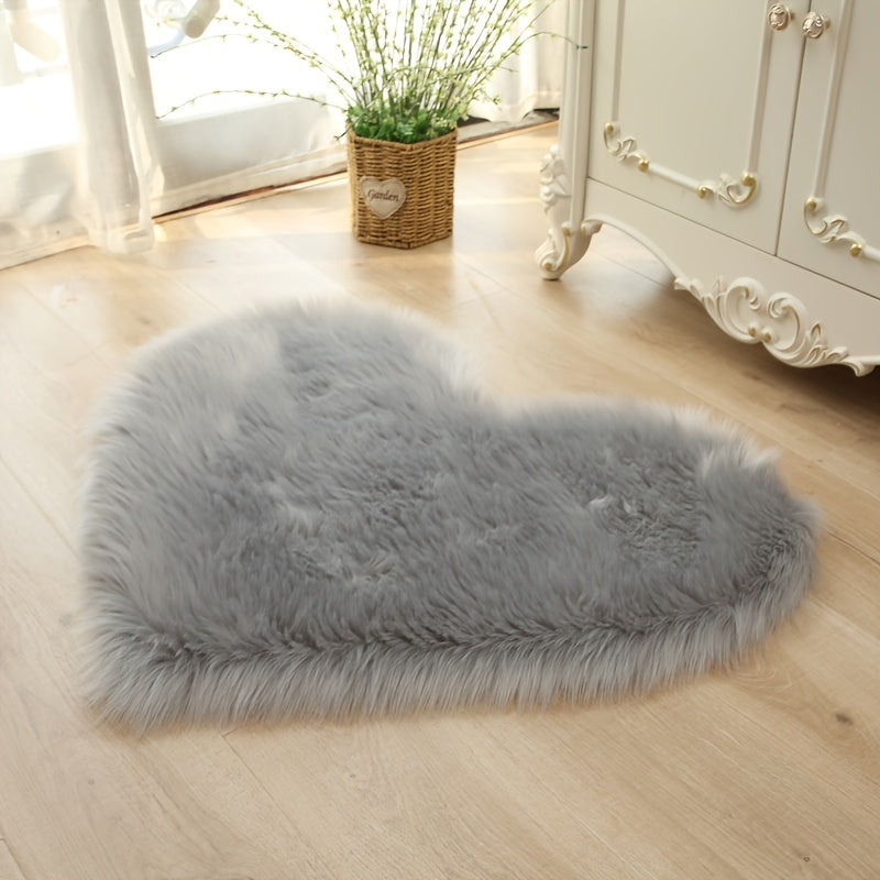 Heart-shaped faux fur rug with long shag pile, light gray plush carpet mat.