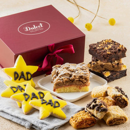 Star-shaped “DAD” cookies, brownie bars, and frosted cookies in a gift box
