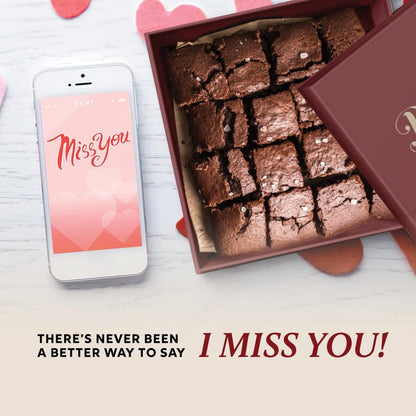 Open gift tin with assorted dark brownie squares