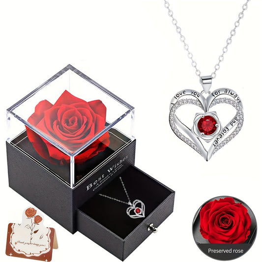 Heart pendant necklace with red gemstone in gift box and preserved red rose