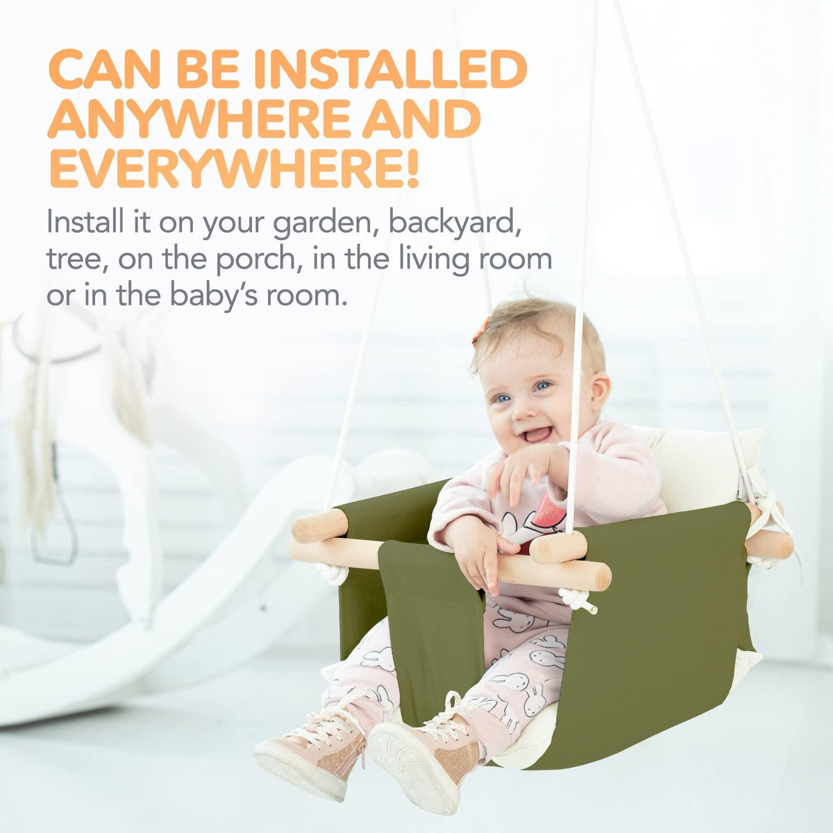 Olive canvas hanging baby swing with white cushions and wooden dowels for toddlers