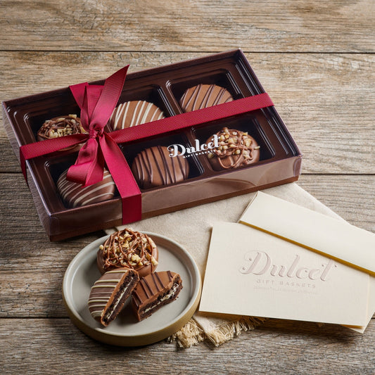 Assorted chocolate-dipped Oreo cookies with white drizzle, in gift box with ribbon