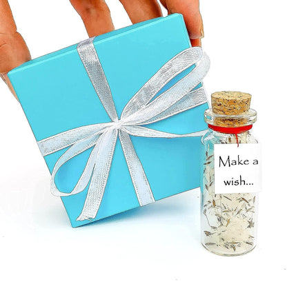 Turquoise gift box with white ribbon bow and miniature wish bottle jar