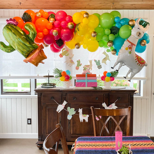 Neon tropical balloon garland arch with alpaca and cactus foil balloons over console