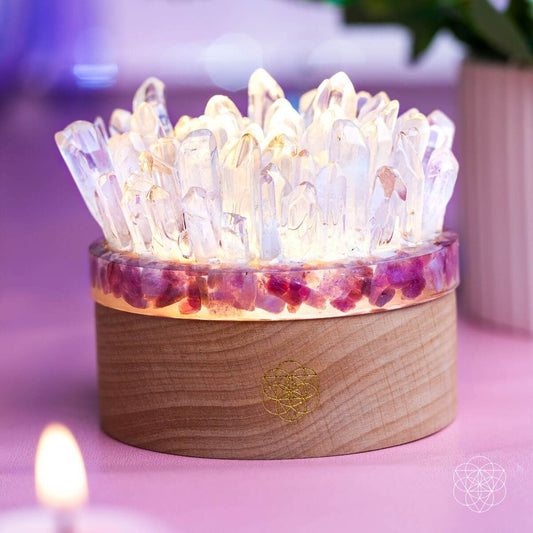 Quartz and tourmaline crystal lamp with wooden base and glowing clear crystal cluster