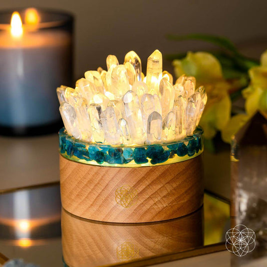Quartz and apatite crystal lamp with teal ring and warm wood base, lit glow