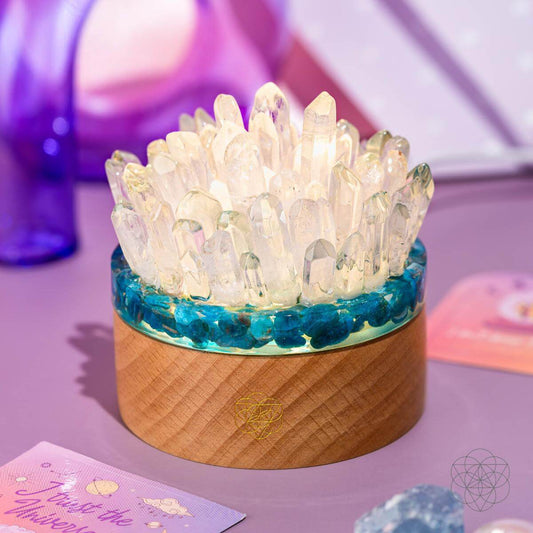 Quartz and apatite crystal lamp with teal band and warm wood base, glowing crystal cluster