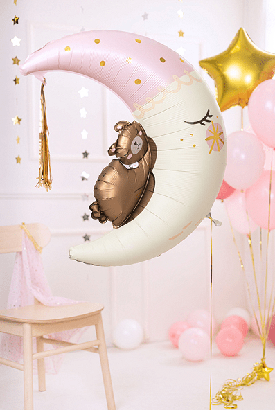 Light pink moon-shaped foil balloon with brown teddy bear and gold tassel