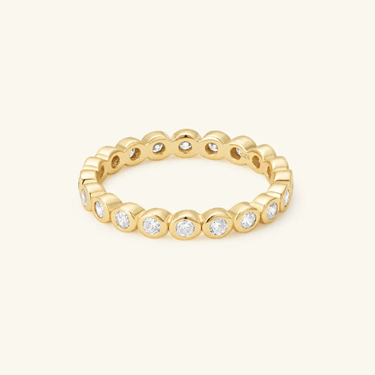Gold-plated eternity ring with round clear CZ stones, beaded prong setting