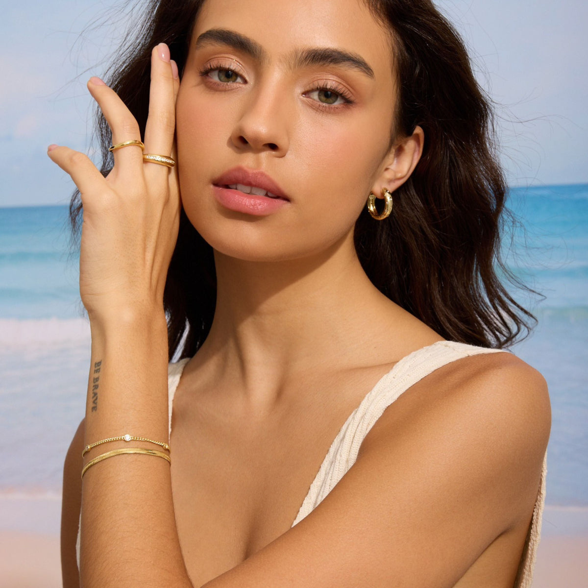 Gold-tone herringbone chain bracelet on wrist near hand