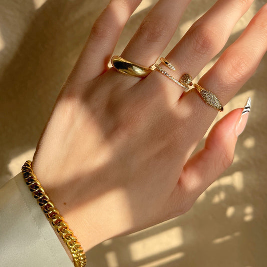 Gold-tone nail ring with row of cubic zirconia on curved open band
