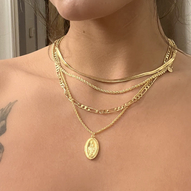 Gold rope-chain pendant necklace with oval Virgin Mary medallion on chain