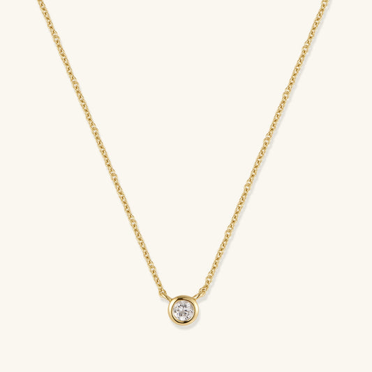 Gold-tone chain necklace with round bezel-set diamond pendant