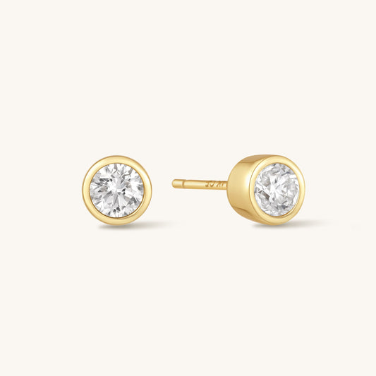 Gold-tone round diamond bezel stud earrings with clear central stone