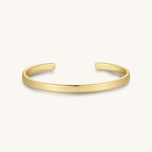 Gold-tone cuff bracelet with smooth, hinged bar design