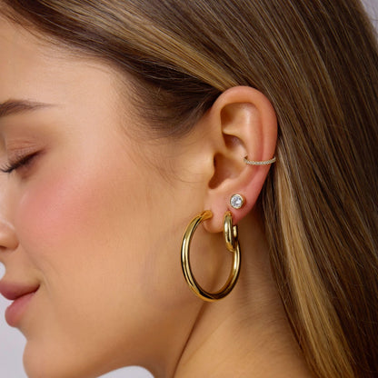 Gold-filled 30mm hoop earrings on ear, polished seamless round hoops