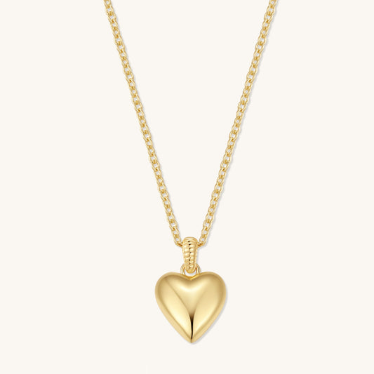 Gold tone heart pendant necklace with puffy heart charm on a fine chain