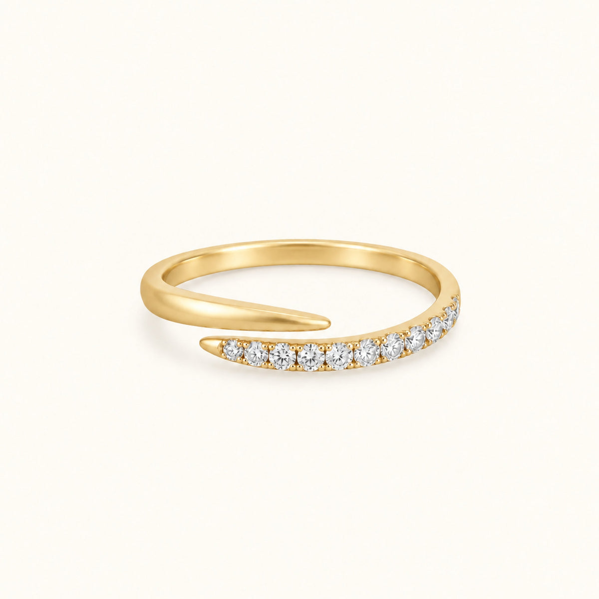 Gold spiral ring with pave white stones along the band and smooth gold top curve