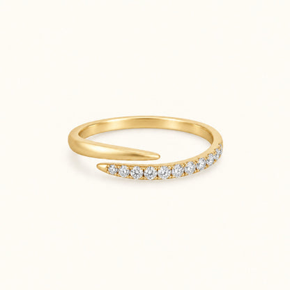Gold spiral ring with pave white stones along the band and smooth gold top curve