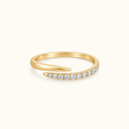 Gold spiral ring with pave white stones along the band and smooth gold top curve
