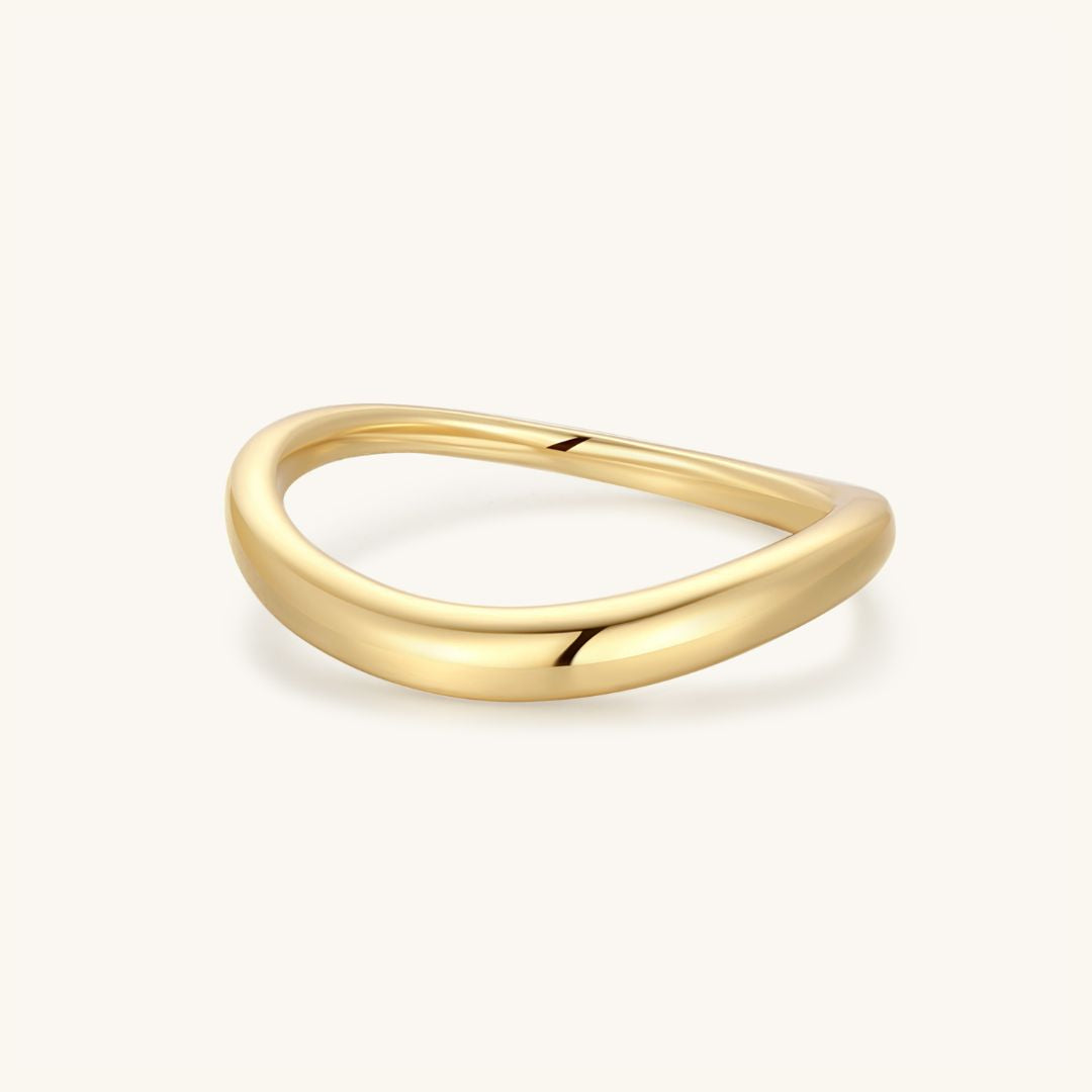 Gold wavy dome ring with a smooth raised top and polished finish