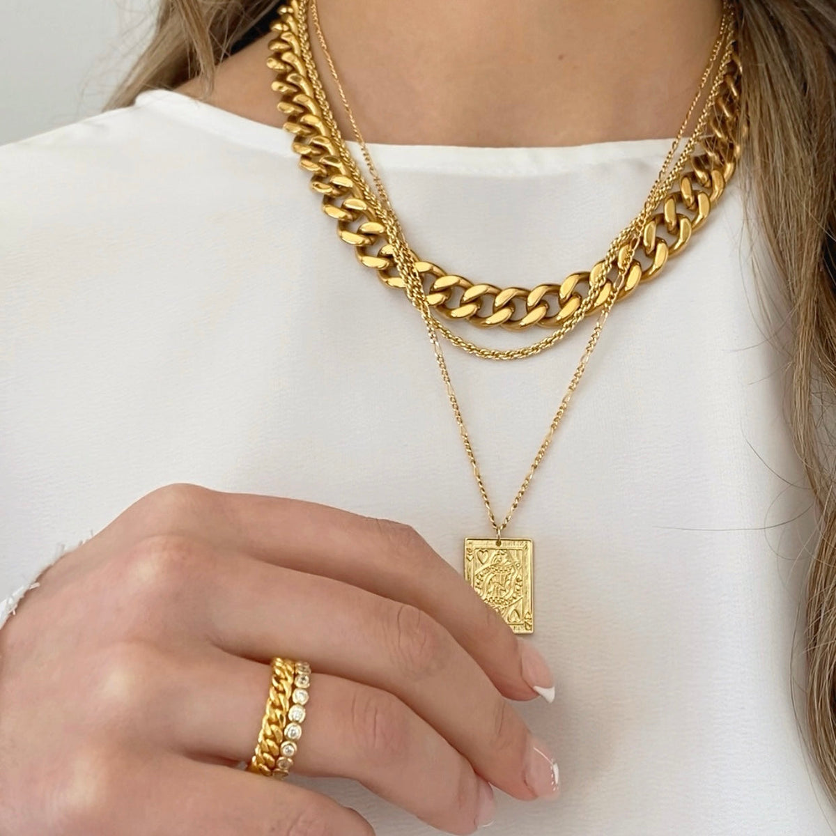 Gold chunky curb chain necklace with rectangle pendant charm, layered on model