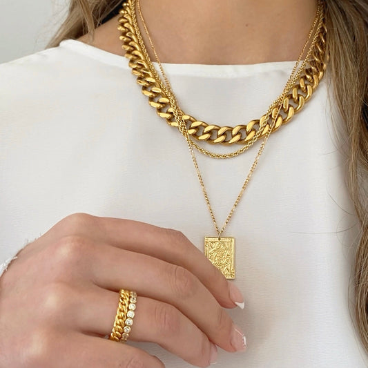 Gold chunky curb chain necklace with rectangle pendant charm, layered on model