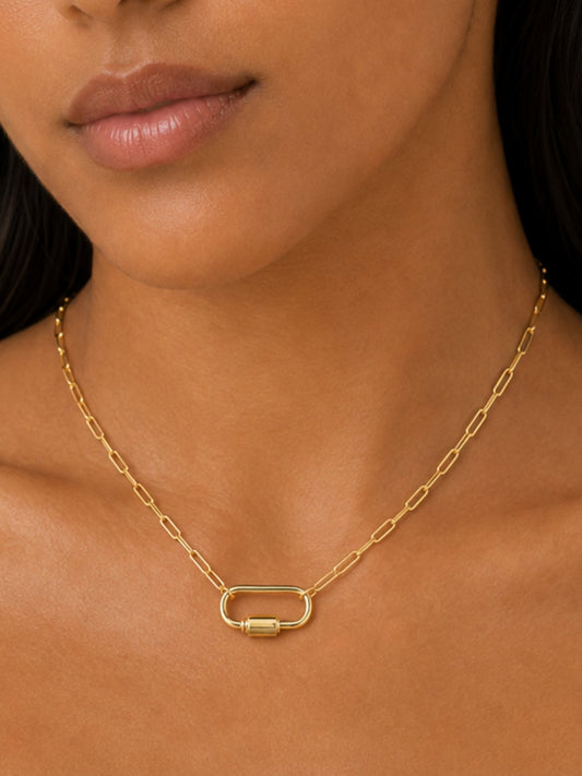 Gold-tone carabiner pendant necklace close-up with rectangular clasp charm