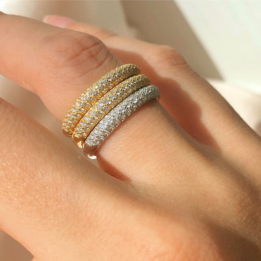 Gold half-eternity three-row cubic zirconia band ring on hand, side view