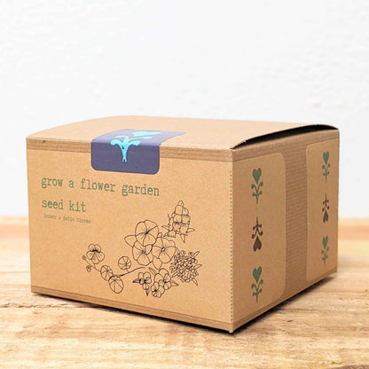 Kraft flower seed kit shipping box with flower artwork and blue handle on top
