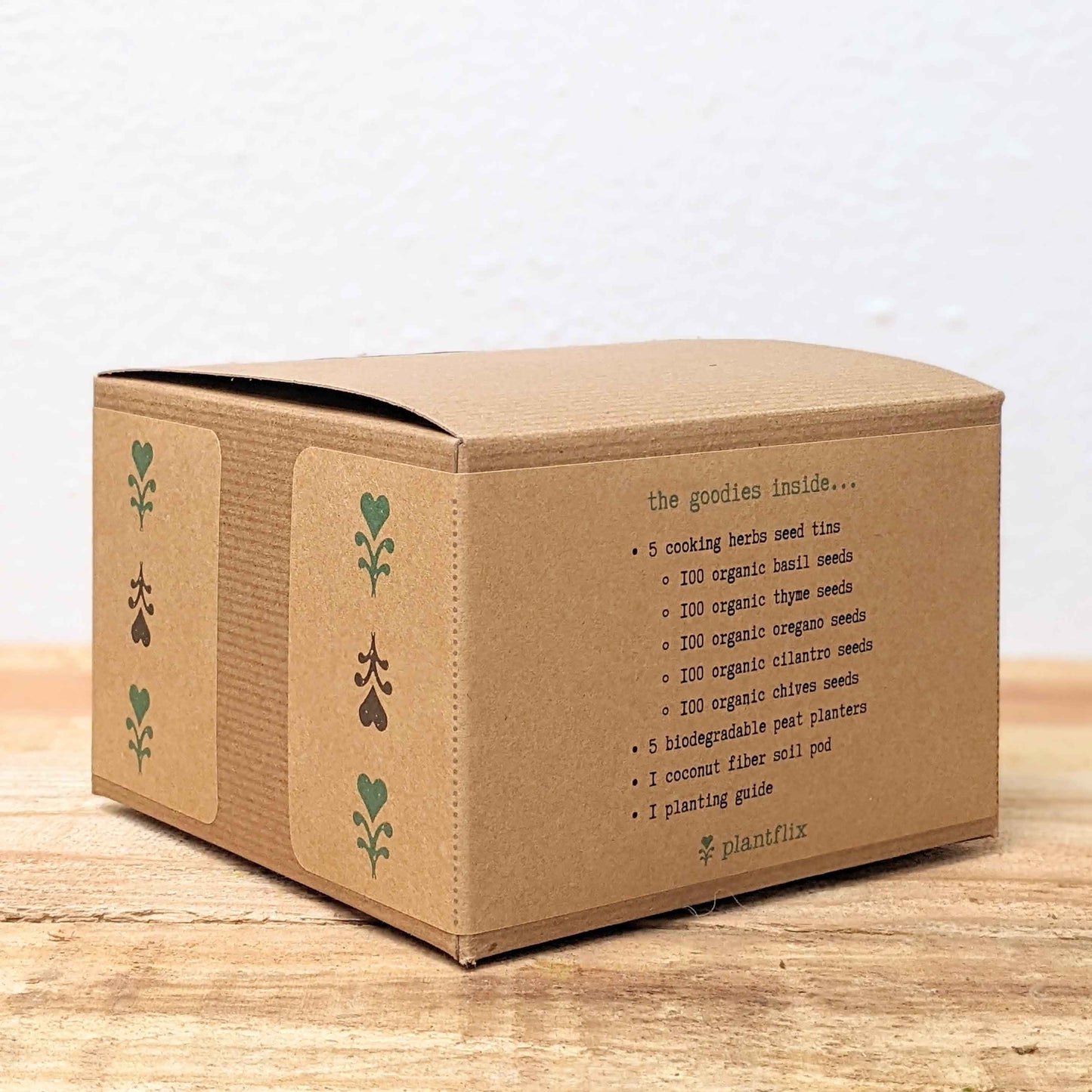 Herb seed kit box side panel with contents list of organic herb seeds and plant pod