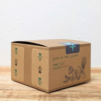Herb seed kit box, brown cardboard with herb icons and 'grow an herb garden' label