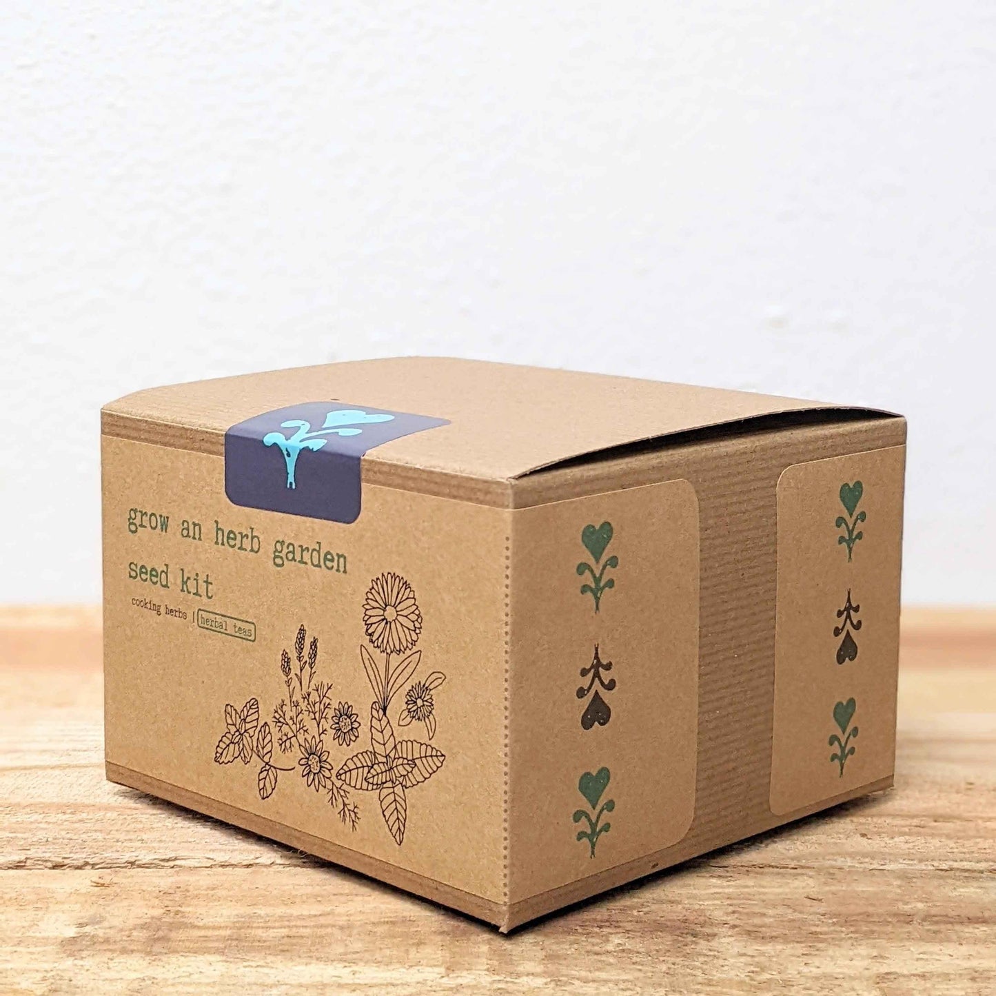 Cardboard seed kit box with grow an herb garden label on the side