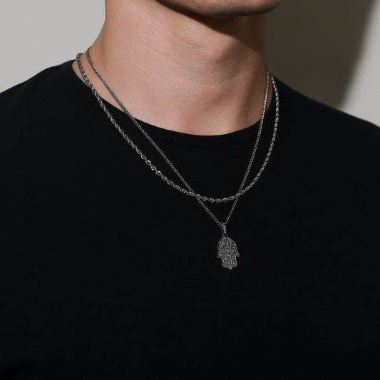 Silver hamsa pendant necklace set with layered rope chains, pendant at center