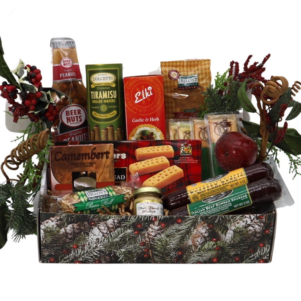 Holiday gift box with assorted gourmet snacks in tray, wreath decor around