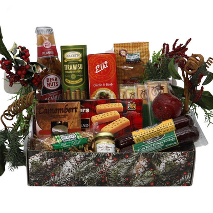 Holiday gift box with assorted gourmet snacks in tray, wreath decor around