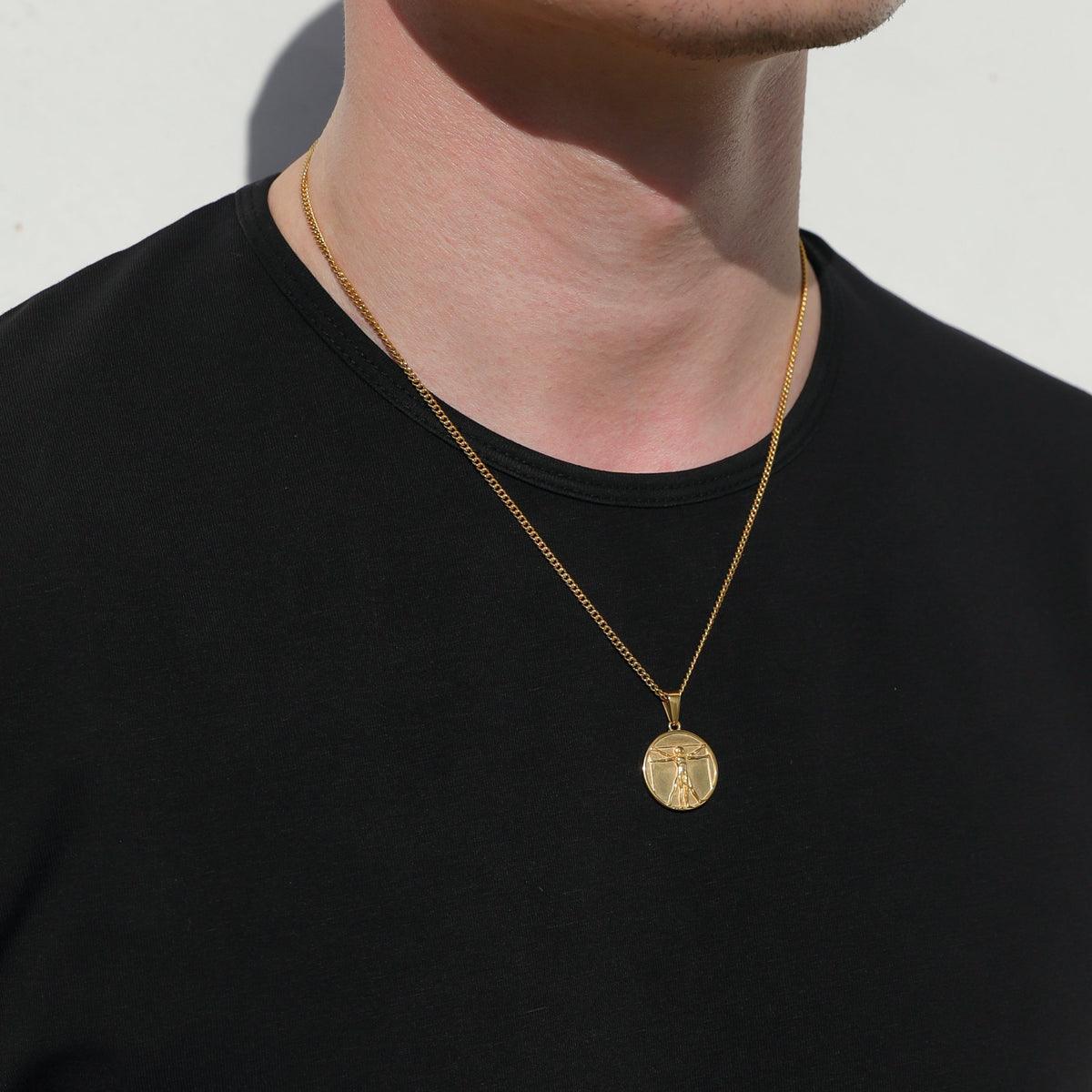 Gold-tone single pendant necklace with round medallion charm and link chain