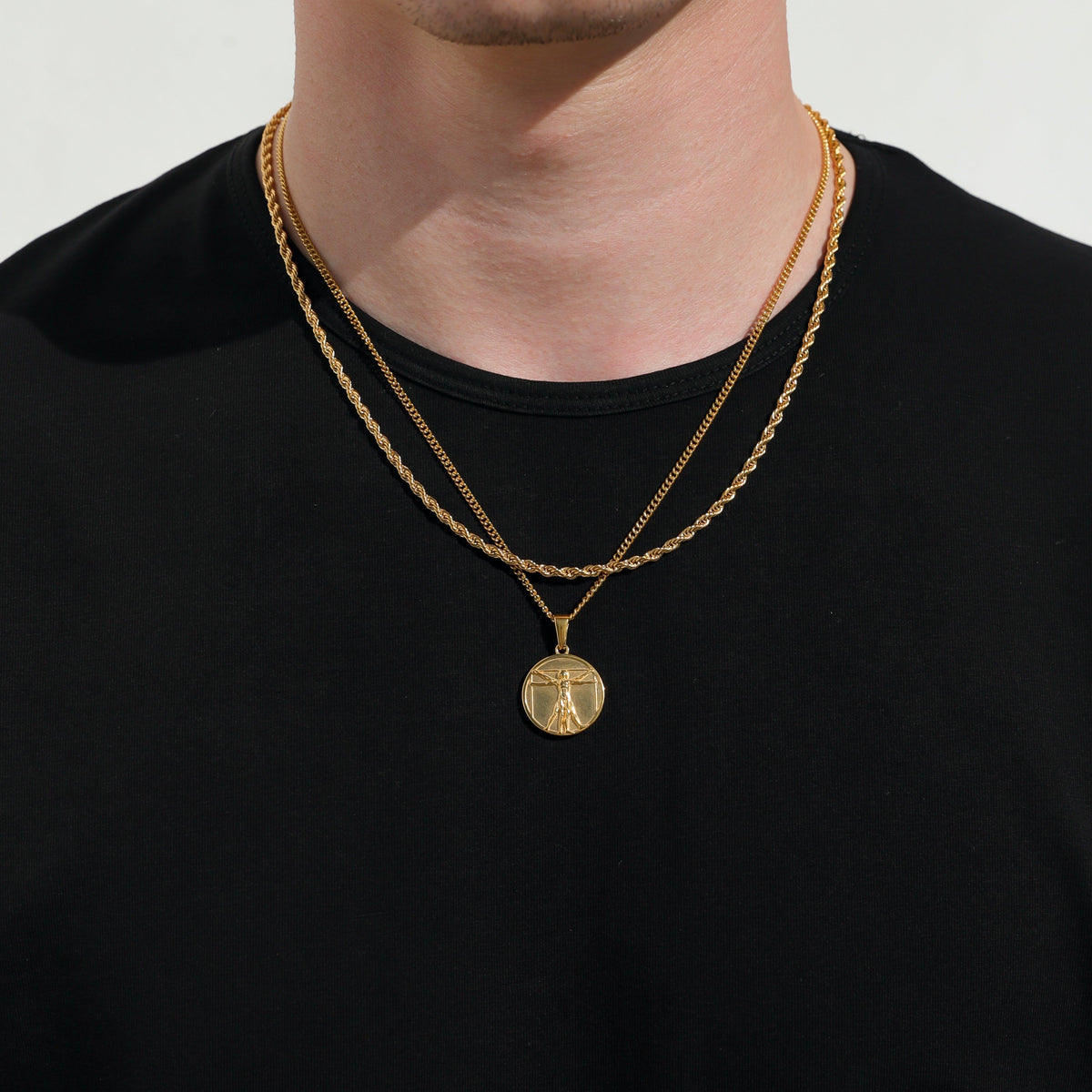 Gold-tone double-layer necklace with round medallion pendant at center