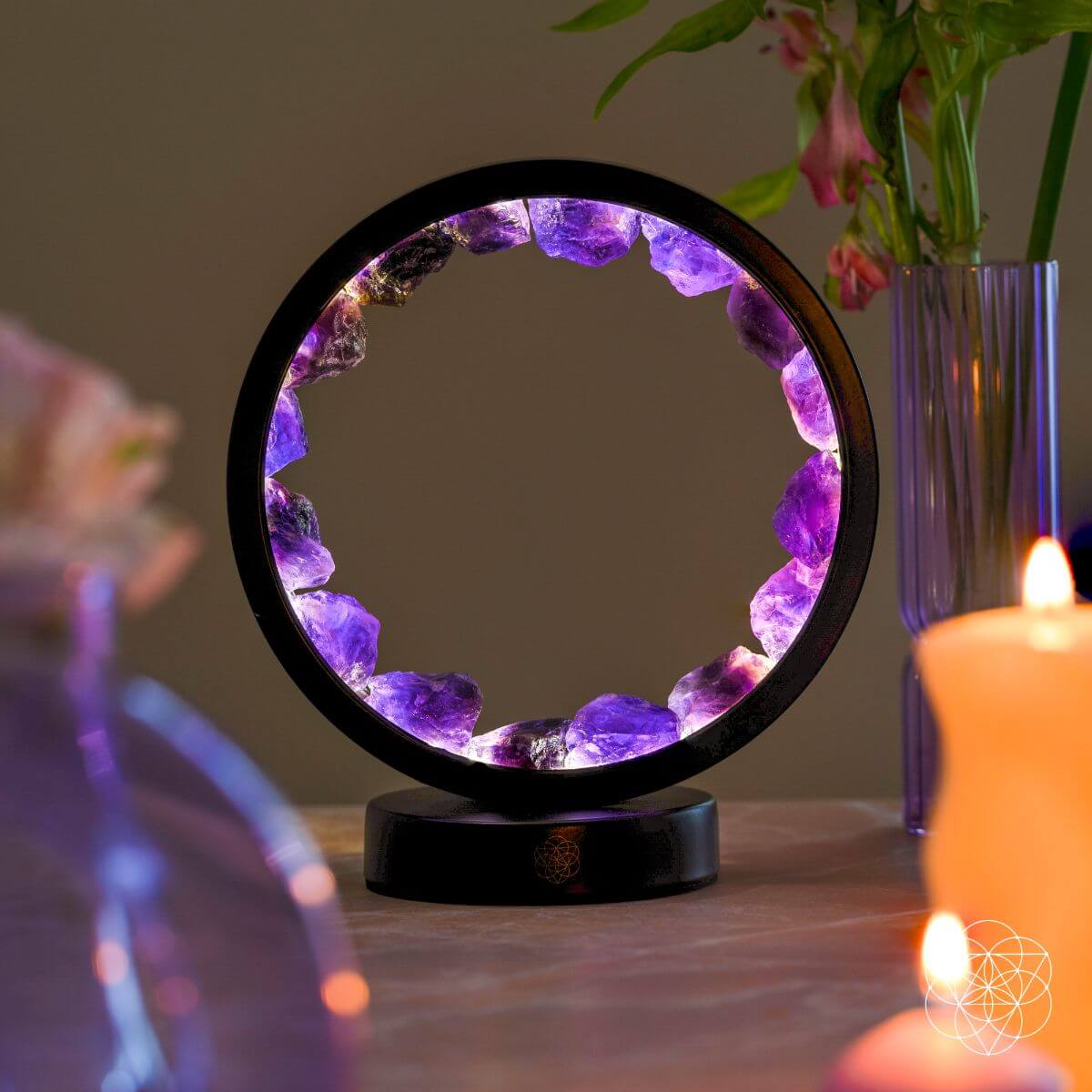 Amethyst halo lamp with purple crystal ring and black base on tabletop