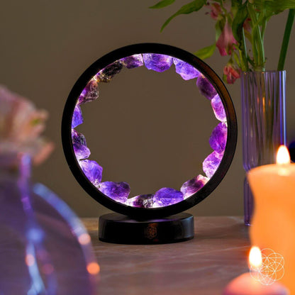 Amethyst halo lamp with purple crystal ring and black base on tabletop