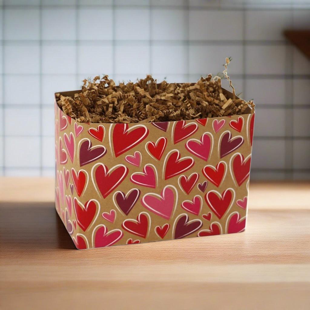 Heart-pattern paper gift box filled with shredded brown filler
