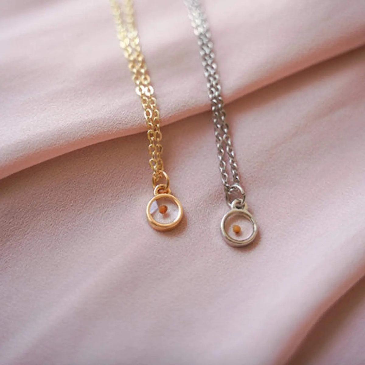 Gold and silver mustard seed necklaces with small round pendants