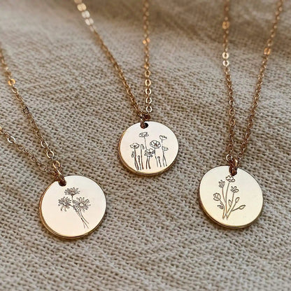 Three round floral pendant necklaces, including the Poppy design