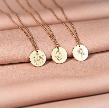 Three gold-tone floral disc necklaces, including a Poppy pendant design